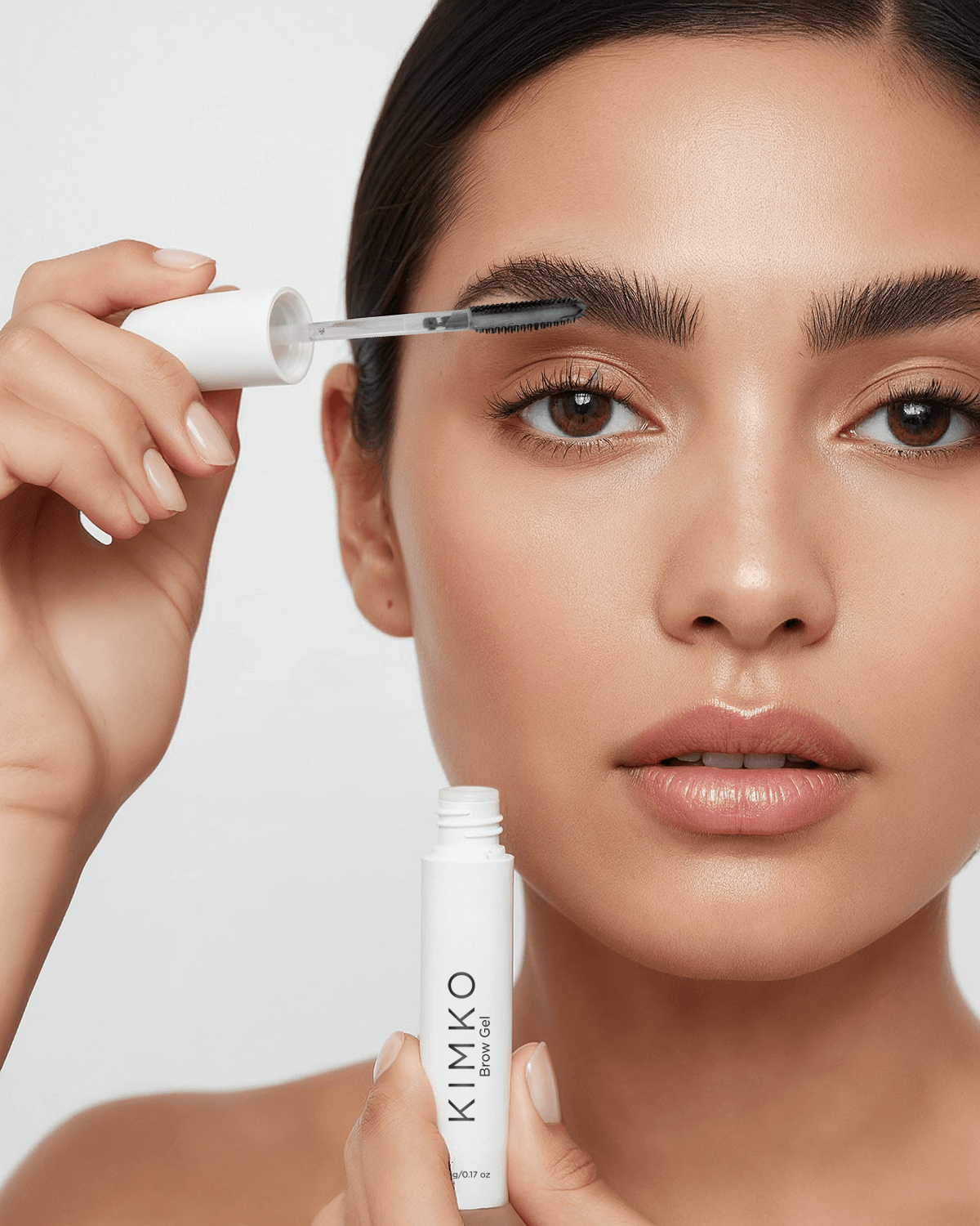 Woman applying KIMKO Brow Gel to sculpt and define her eyebrows 